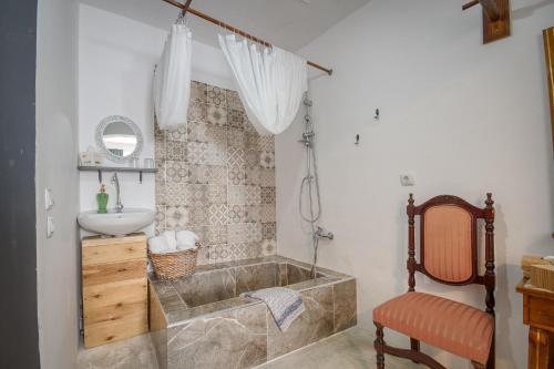 a bathroom with a tub and a sink at Mascot Boutique Hotel in Rhodes Town