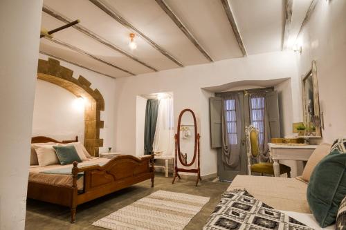 a bedroom with a bed and a mirror at Mascot Boutique Hotel in Rhodes Town