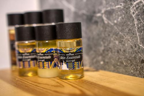 three bottles of essential oils sitting on a table at Mascot Boutique Hotel in Rhodes Town