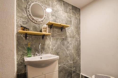 a bathroom with a sink and a mirror at Mascot Boutique Hotel in Rhodes Town