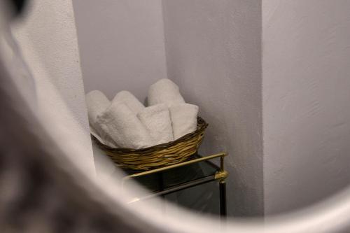 a basket of towels on a shelf in a room at Mascot Boutique Hotel in Rhodes Town