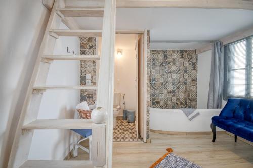 a room with a ladder and a blue couch at Mascot Boutique Hotel in Rhodes Town