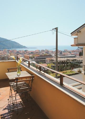 a balcony with a table and a view of a city at Bed & Breakfast Spigolatrice in Sapri