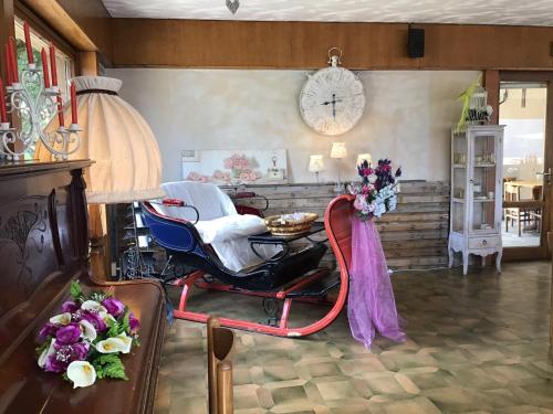 a living room with a wheelchair and a clock on the wall at Hotel Mirabeau in Bellagio