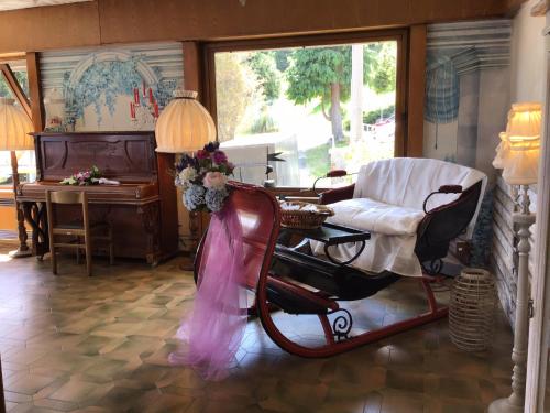 a living room with a rocking chair and a table at Hotel Mirabeau in Bellagio