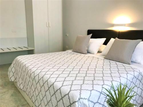 a bedroom with a large bed with a white comforter at Innsud in Nardò