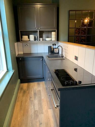 a kitchen with a sink and a stove top oven at The Nook, Morpeth Town in Morpeth