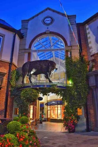 a statue of a dog standing on top of a building at The Nook, Morpeth Town in Morpeth