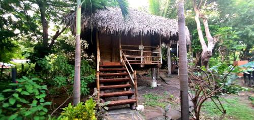 a small hut with a staircase leading up to it at Hotel Restaurante Spa La Barca de Oro in Las Peñitas