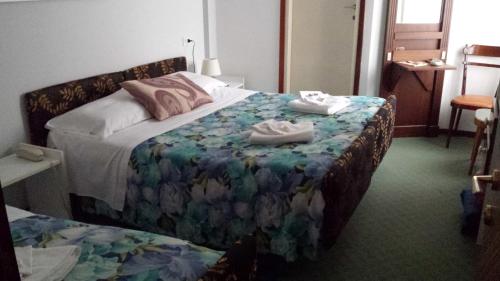 a hotel room with a bed with towels on it at Hotel Mirabeau in Bellagio