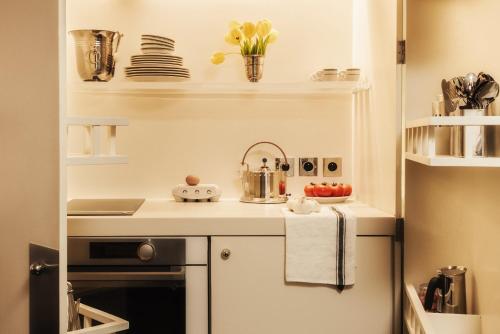 a small kitchen with a sink and a stove at Pied A Terre - Tuileries in Paris