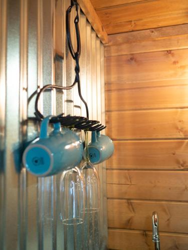 a glass bottle hanging on a wall next to a sink at Z Ranch in Templeton