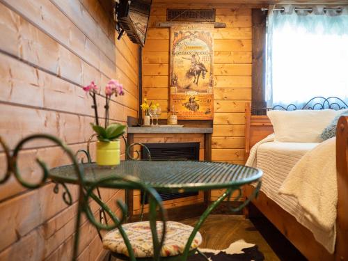 a room with a table and a fireplace in a cabin at Z Ranch in Templeton