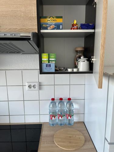 two bottles of water sitting on a counter in a kitchen at Zimmer für Monteure, Handwerker oder Reisende in Essen