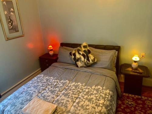a bedroom with a bed and two night stands with lamps at Stylish, Cozy 2BR Private Apt, 2nd Floor, Scenic View, Well-Appointed, Near Providence, MA, RI Line, I-95 Access in Pawtucket