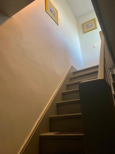 a stairway with a stair case in a building at Stylish, Cozy 2BR Private Apt, 2nd Floor, Scenic View, Well-Appointed, Near Providence, MA, RI Line, I-95 Access in Pawtucket