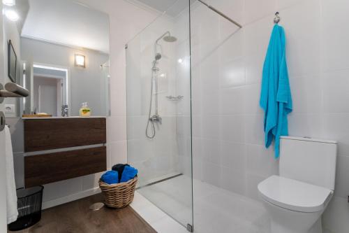 a bathroom with a glass shower and a toilet at Francisco Terrace in Ponta Delgada