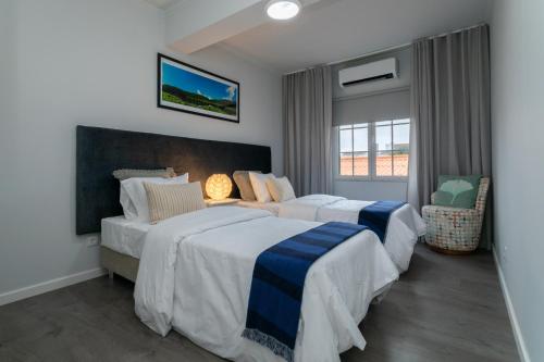 a hotel room with two beds and a window at Francisco Terrace in Ponta Delgada