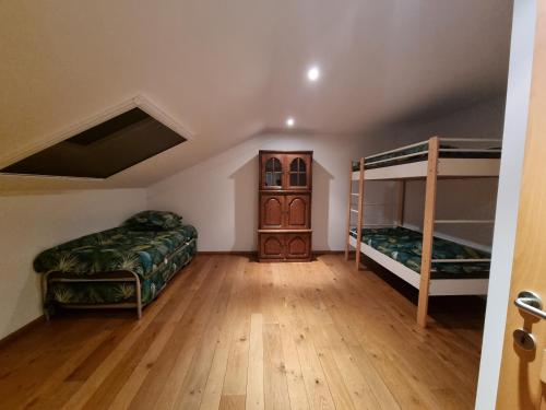 a room with two bunk beds and a cabinet at SusBerg-1 & 2 in Neerpelt