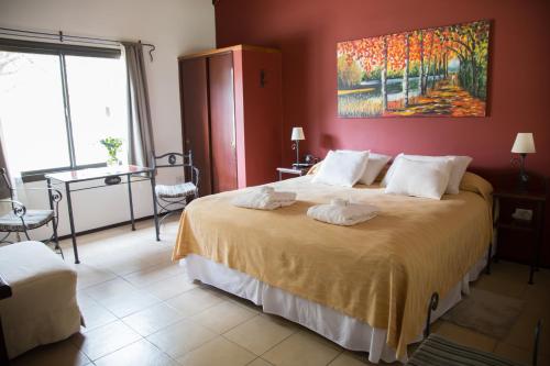 a bedroom with a large bed with a painting on the wall at La Quinta Resort in Merlo