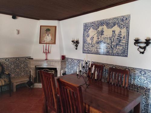 a dining room with a table and a fireplace at Fazenda do Marante in Tomar