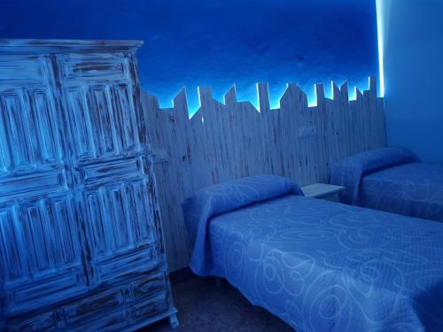 Ένα ή περισσότερα κρεβάτια σε δωμάτιο στο Hostal Pabellón