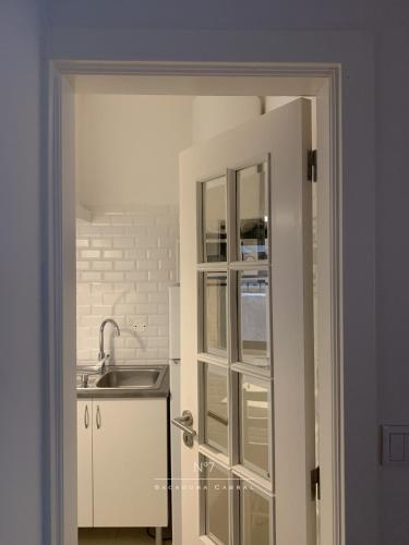 an open door to a kitchen with a sink at Nº7 Sacadura Cabral in Guarda