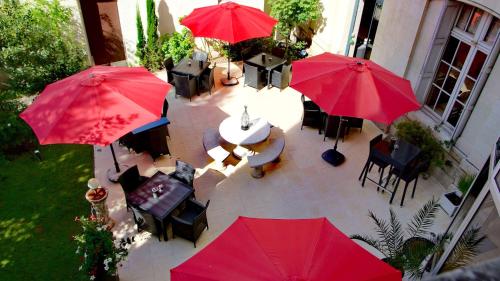 an overhead view of a patio with red umbrellas at Best Western Central Hotel in Tours