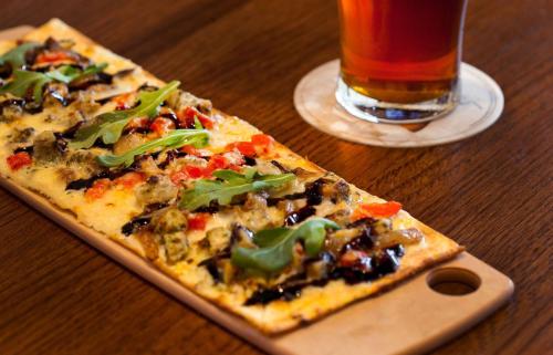 a slice of pizza on a table with a drink at Sonesta Atlanta Airport South in Atlanta
