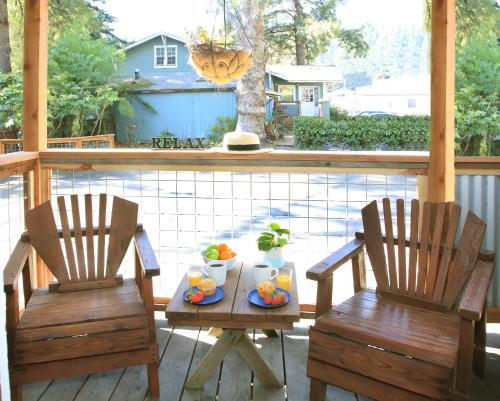 2 Stühle und ein Tisch mit Obst auf der Veranda in der Unterkunft Inn on the Russian River in Monte Rio