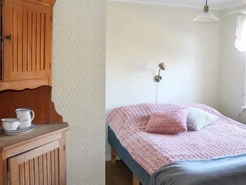 a bedroom with a bed and a table with a lamp at 5 person holiday home in Fjärås-By Traum in Fjärås