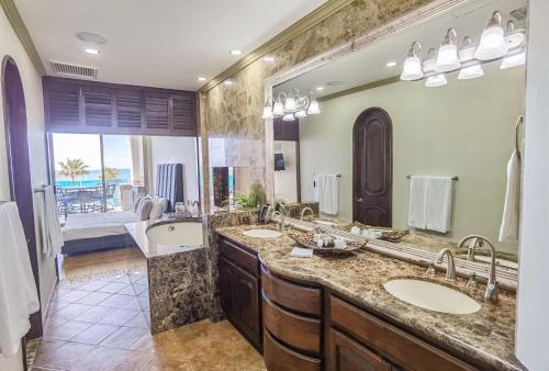 a bathroom with two sinks and a large mirror at Esmeralda by TO in Puerto Peñasco