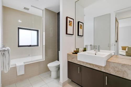 a bathroom with a sink and a toilet at Peppers Moonah Links Resort in Fingal