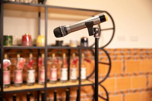 a microphone in front of a rack of bottles at 新龍頭古厝行館 Shin Long Tou B&B in Jinning