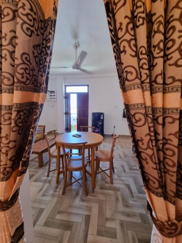 a dining room with a table and chairs at Grand Station Residence (Rose) in Seeduwa