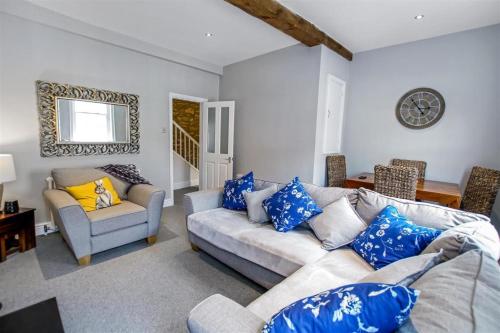 a living room with a couch and a chair at Comfy Dales holiday base on Market Place of historic market town in Richmond
