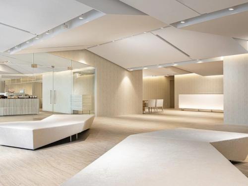 a large room with a bed and a table at Hotel Royal Classic Osaka in Osaka