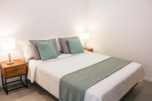 a bedroom with a large bed and two lamps at Blue Vista - 1 bedroom condo in Nettle Bay in Marigot