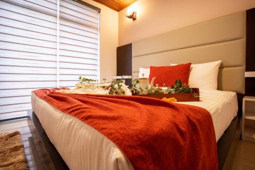 a bedroom with a large bed with flowers on it at Moon Plains Luxury Apartments in Nuwara Eliya