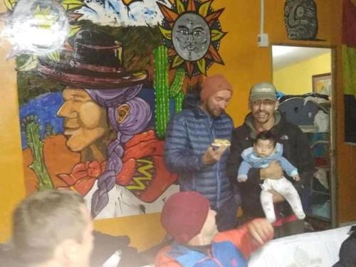 a group of people standing in front of a painting at Monkeywasi Climbing Hostel in Huaraz