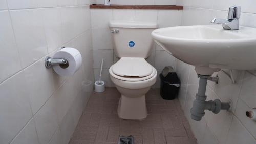a bathroom with a toilet and a sink at Casa La Palma Habitación Cielo in Medellín