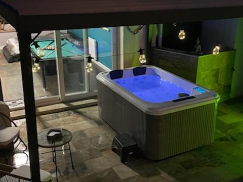 - un grand bain à remous dans une pièce avec une table et des chaises dans l'établissement Bulle d'évasion, à Trèbes