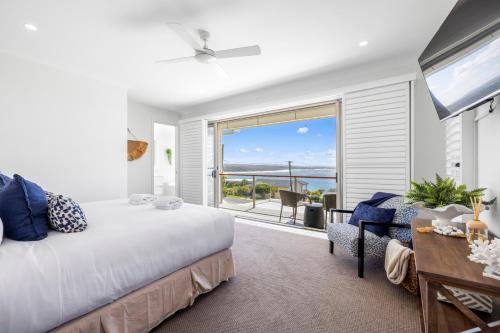 a bedroom with a bed and a view of the ocean at Horizons in Woolgoolga