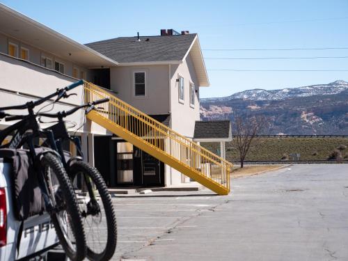 a bike parked next to a building with a yellow ramp at Balanced Rock Inn in Fruita