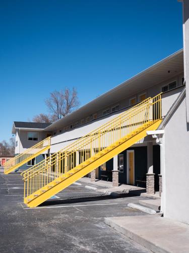 a yellow staircase leading up to a building at Balanced Rock Inn in Fruita