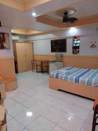a bedroom with a bed and a kitchen and a table at Kokomos Hotel and Restaurant in Angeles