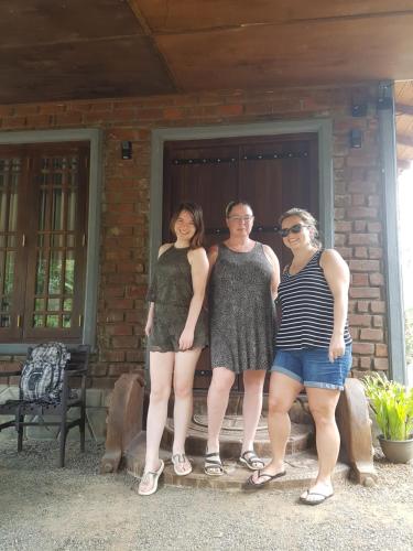 three women standing in front of a house at Ceylon Resort in Wilpattu