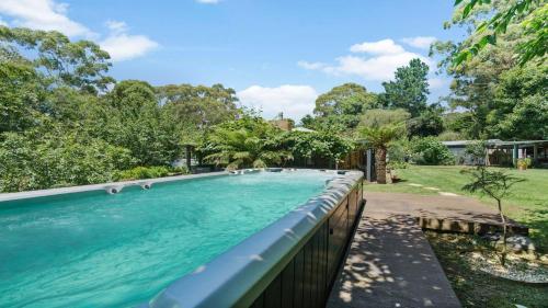 a swimming pool in the backyard of a house at Alba Gardens in Bundanoon