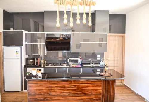 a kitchen with a black counter top and a refrigerator at VILLA MARIA PETRA in Wadi Musa