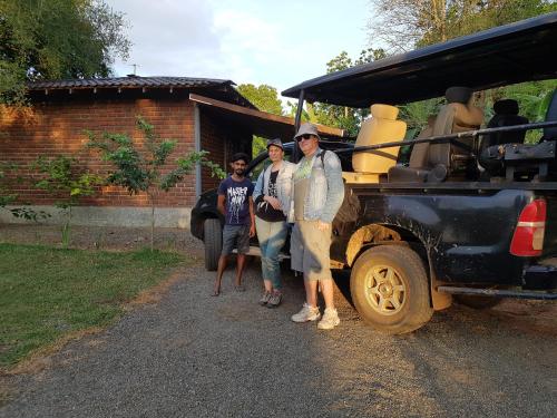 a group of people standing next to a vehicle at Ceylon Resort in Wilpattu